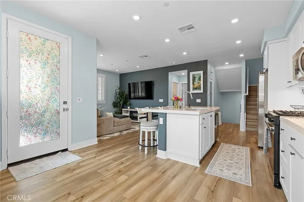 a view of kitchen with cabinets and wooden floor