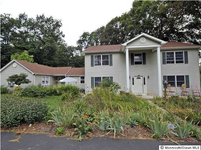 134 Waterworks Road Freehold, NJ 07728 - Photo 1 of 3 a front view of a house with a yard