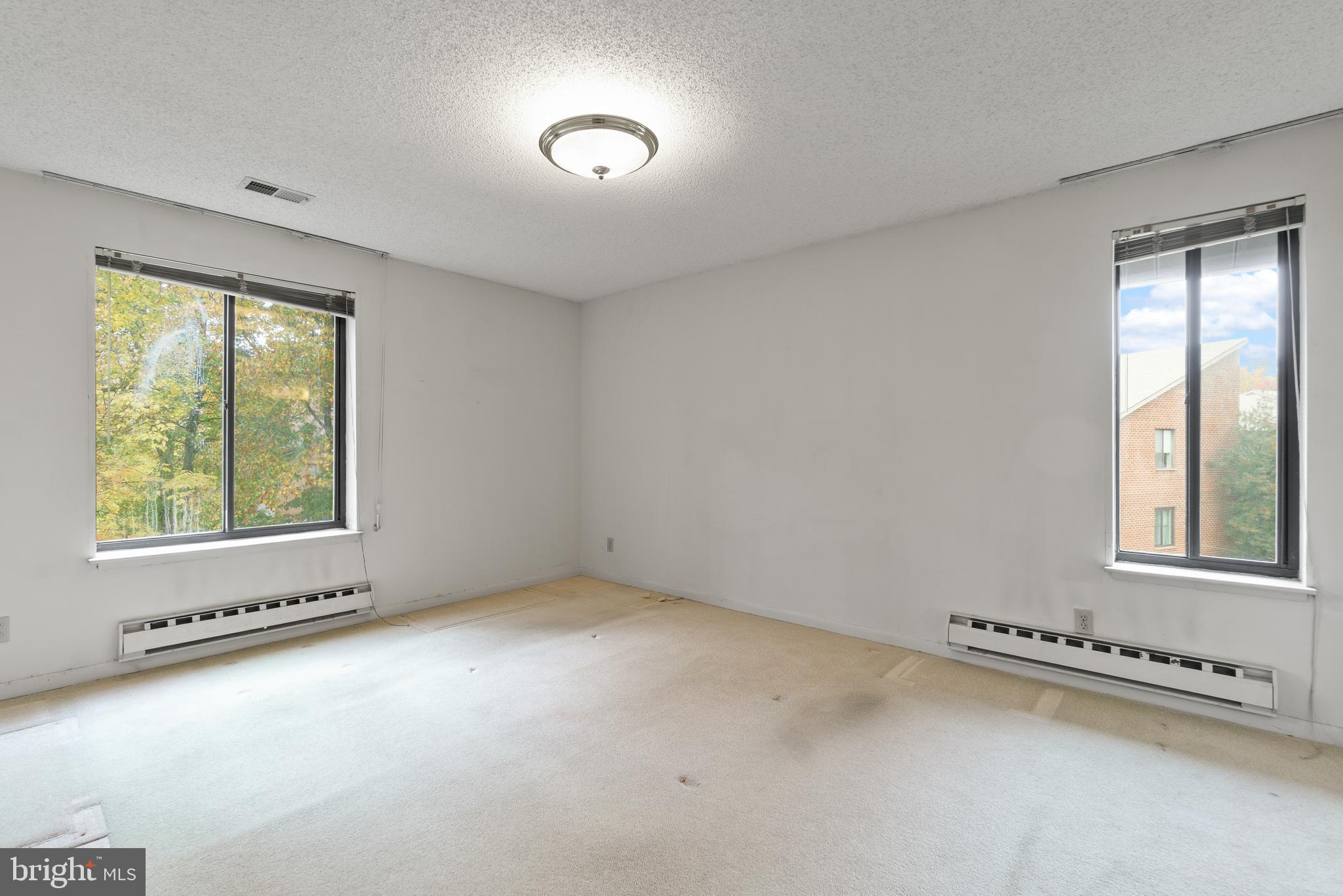 15300 Beaverbrook Court, Unit 883F Silver Spring, MD 20906 - Photo 14 of 31 an empty room with windows