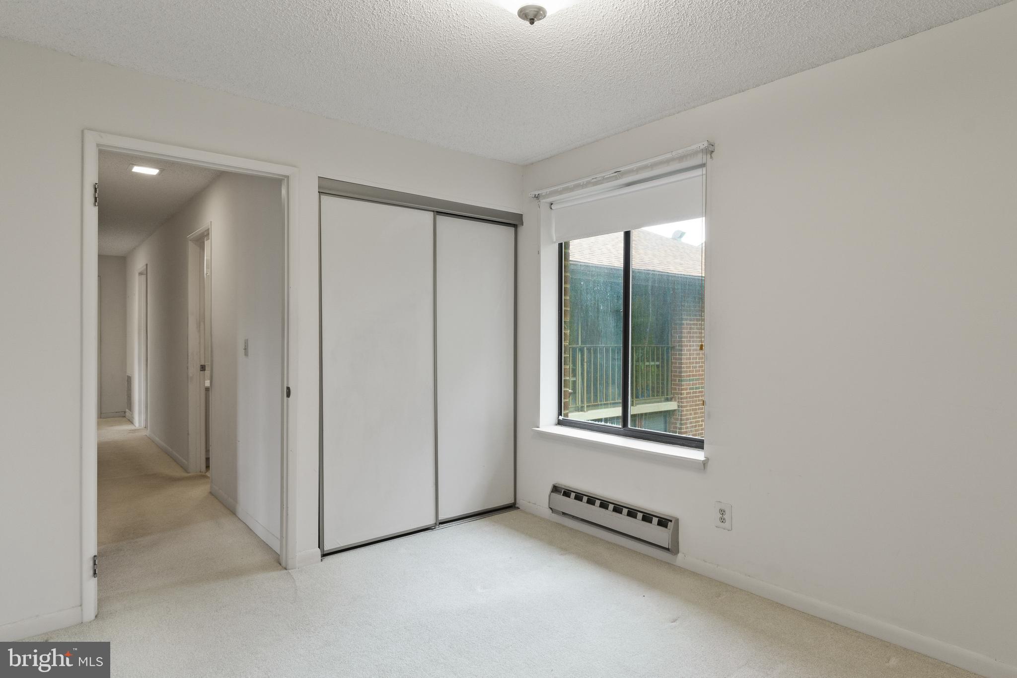 15300 Beaverbrook Court, Unit 883F Silver Spring, MD 20906 - Photo 18 of 31 an empty room with windows and closet