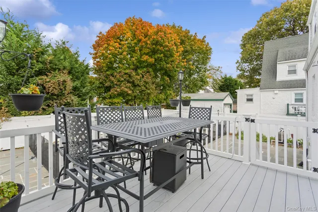 a view of a dinning table and chairs on the roof deck