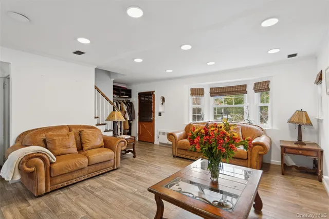 a living room with furniture gym equipment and a large window