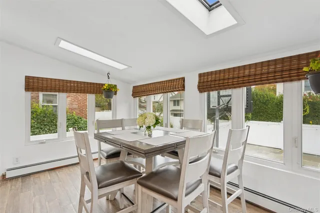 a view of a dining room with furniture large windows and wooden floor