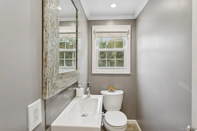 a white toilet sitting next to a bathroom sink