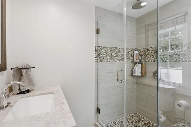 a bathroom with a sink and shower