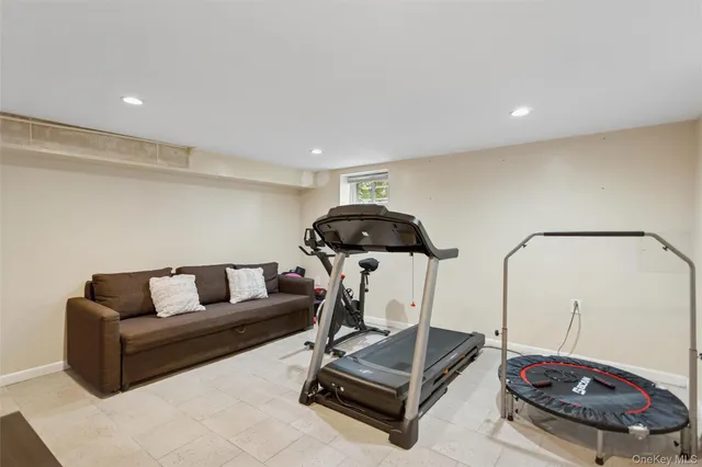 a living room with furniture and a mirror