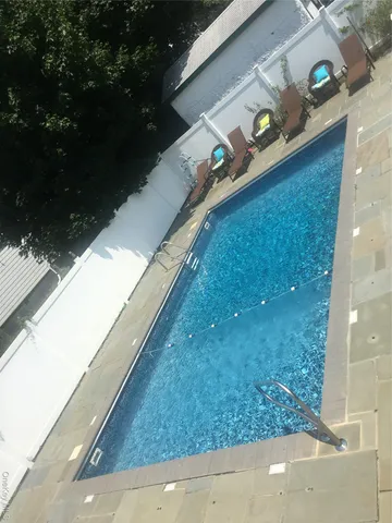 a view of swimming pool from a balcony