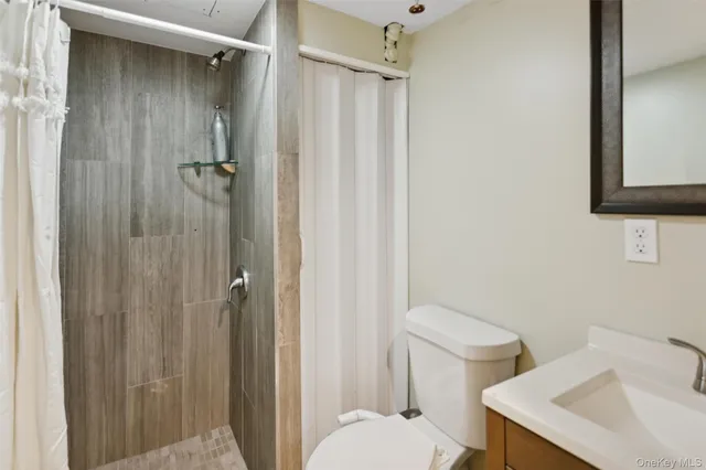 a white toilet sitting next to a bathroom sink