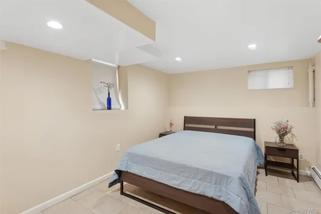 a bedroom with a bed and a potted plant