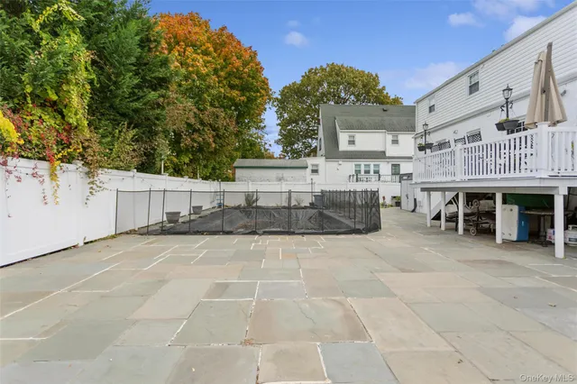 a view of a patio with dining table and chairs under an umbrella