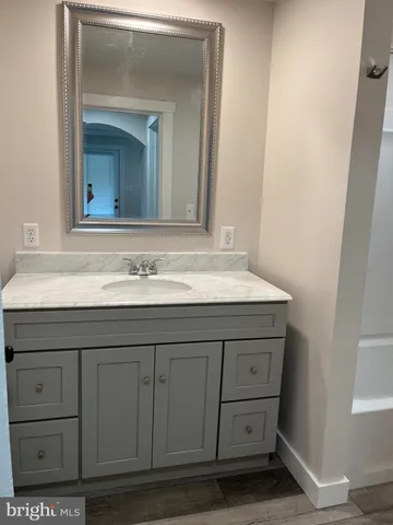 a bathroom with a sink vanity and mirror