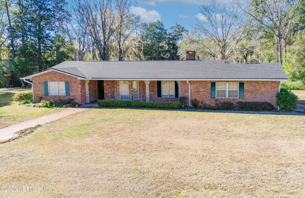 a aerial view of a house with a yard and sitting area