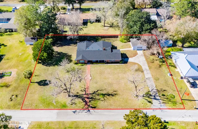 an aerial view of a house with a yard