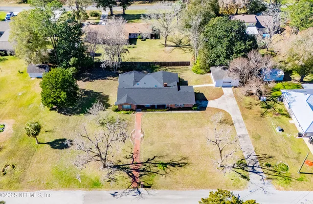 an aerial view of a house with a yard