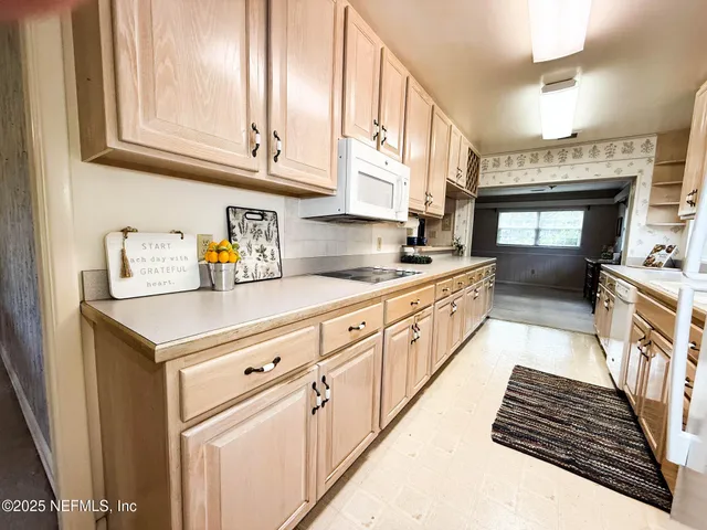 a kitchen with stainless steel appliances a sink stove and cabinets