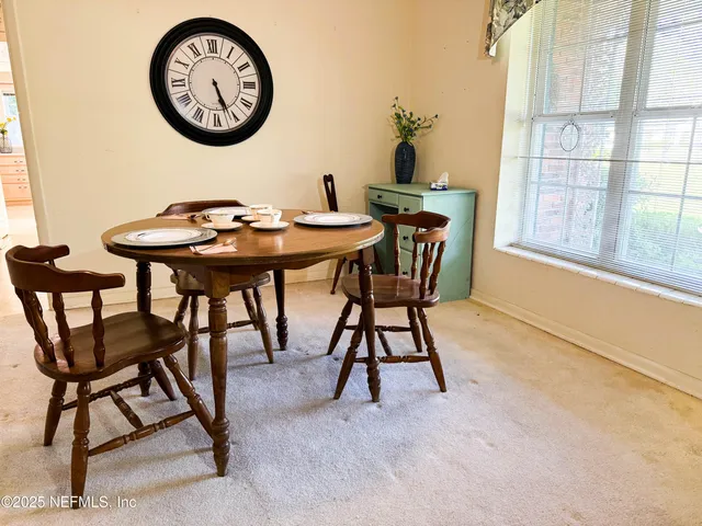 a view of a livingroom with furniture and a window