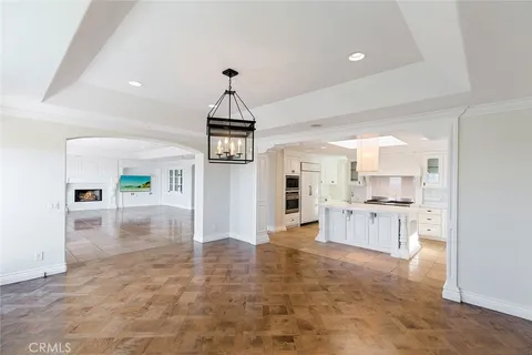a open kitchen with white cabinets and stainless steel appliances