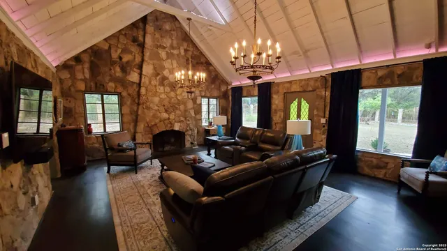 a living room with furniture a chandelier a fireplace and a chandelier