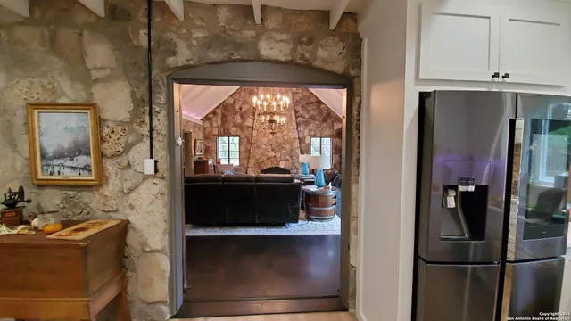 a kitchen with stainless steel appliances a refrigerator and a wooden cabinets
