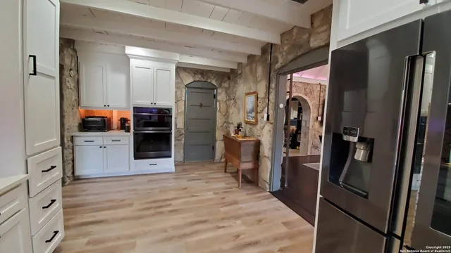 a kitchen with stainless steel appliances a sink stove and cabinets
