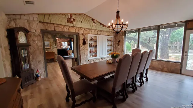a view of a dining room with furniture and wooden floor