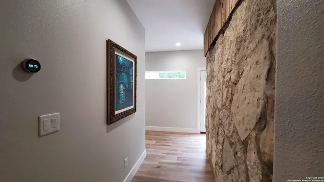 a bathroom with a sink a toilet a mirror and shower