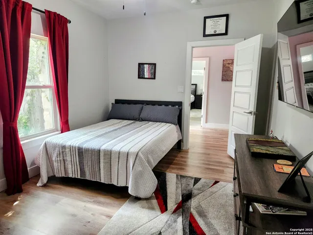 a bedroom with a bed and a window