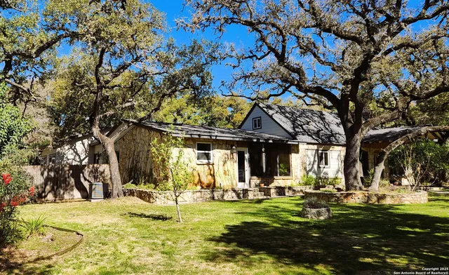 a view of a house with swimming pool and sitting area