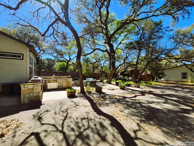 a front view of a house with a yard covered with snow in front of house