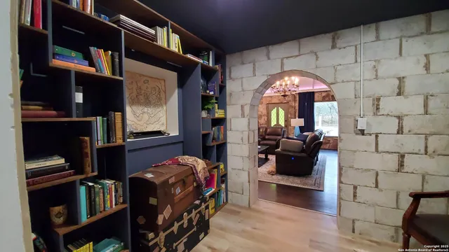 a view of a bedroom with workspace and window