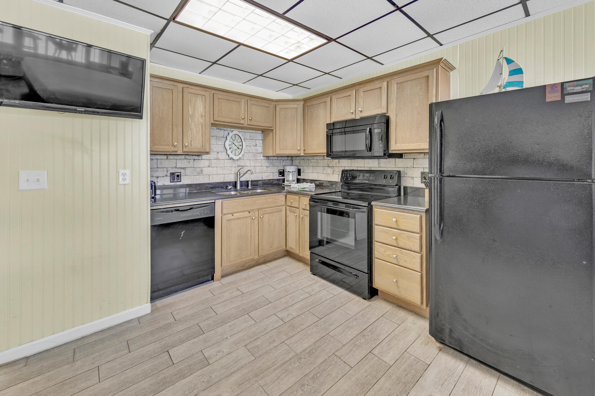 15413 Front Beach Road, Unit 406 Panama City Beach, FL 32413 - Photo 9 of 21 a kitchen with stainless steel appliances granite countertop a stove a sink dishwasher a refrigerator and a microwave oven