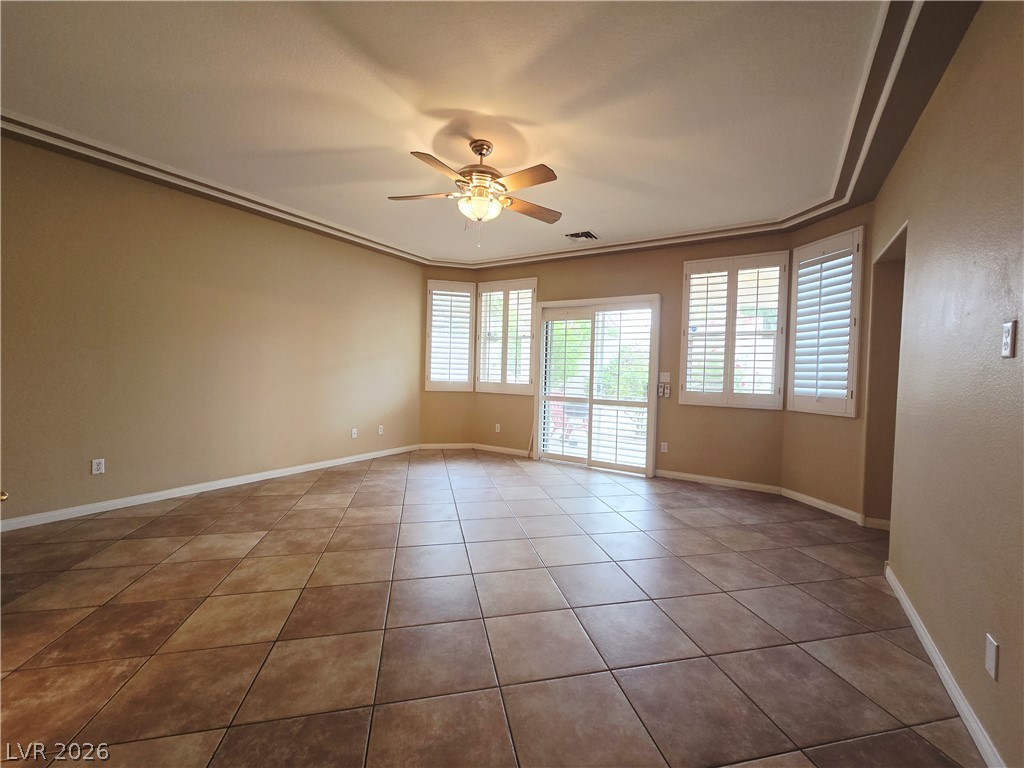 1265 Moon Vision Street Henderson, NV 89052 - Photo 19 of 35 Empty room with ceiling fan and light tile patterned floors