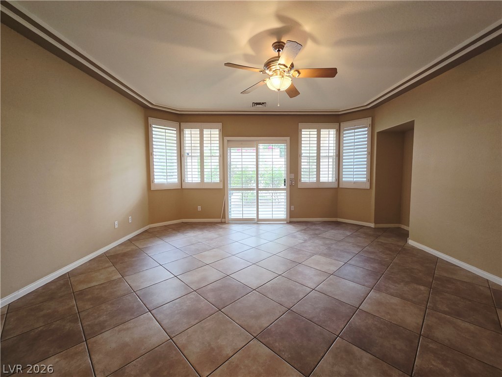1265 Moon Vision Street Henderson, NV 89052 - Photo 20 of 35 Empty room with ceiling fan, healthy amount of natural light, and tile patterned floors