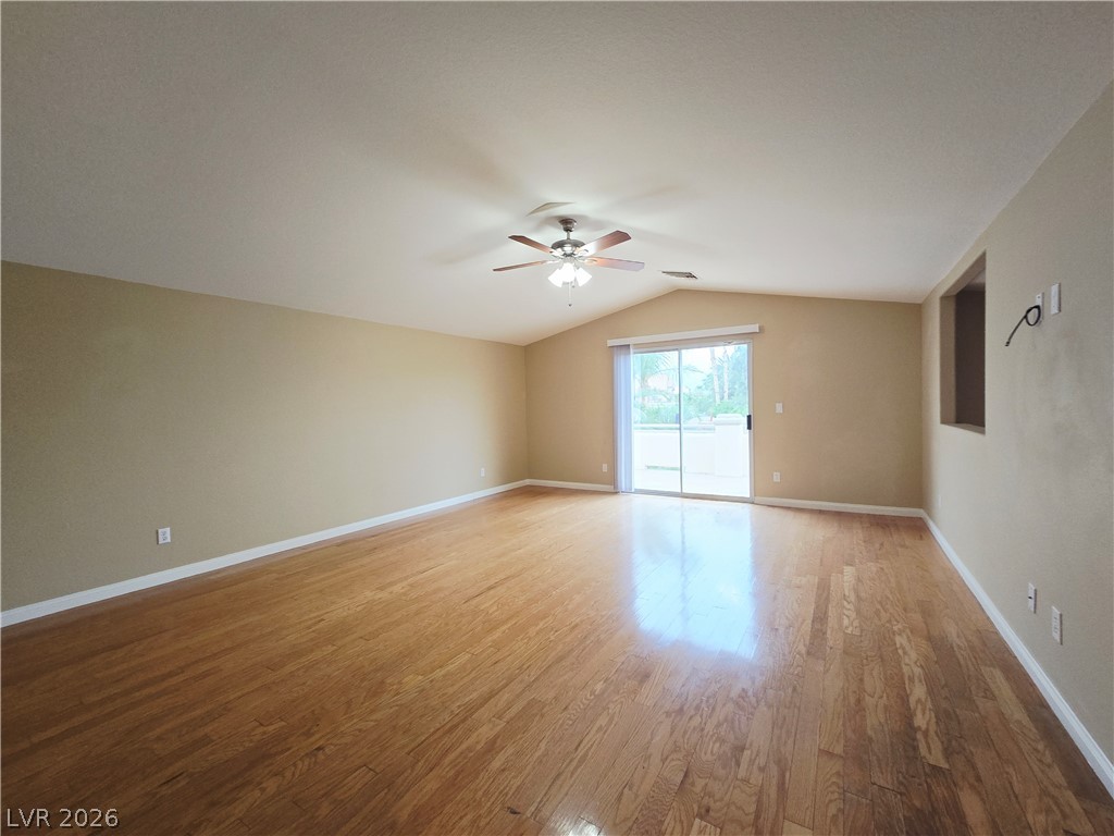 1265 Moon Vision Street Henderson, NV 89052 - Photo 25 of 35 Empty room featuring vaulted ceiling, light wood-style floors, and a ceiling fan