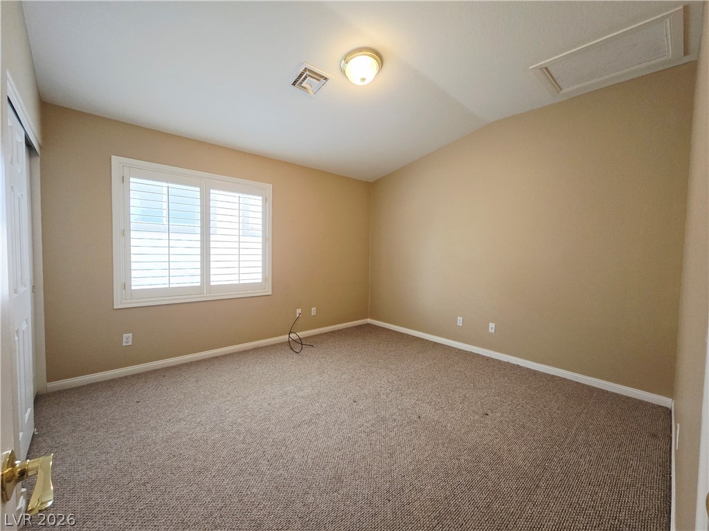 1265 Moon Vision Street Henderson, NV 89052 - Photo 26 of 35 Unfurnished bedroom featuring a closet, lofted ceiling, and light colored carpet