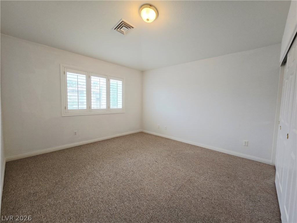 1265 Moon Vision Street Henderson, NV 89052 - Photo 28 of 35 Carpeted spare room featuring baseboards
