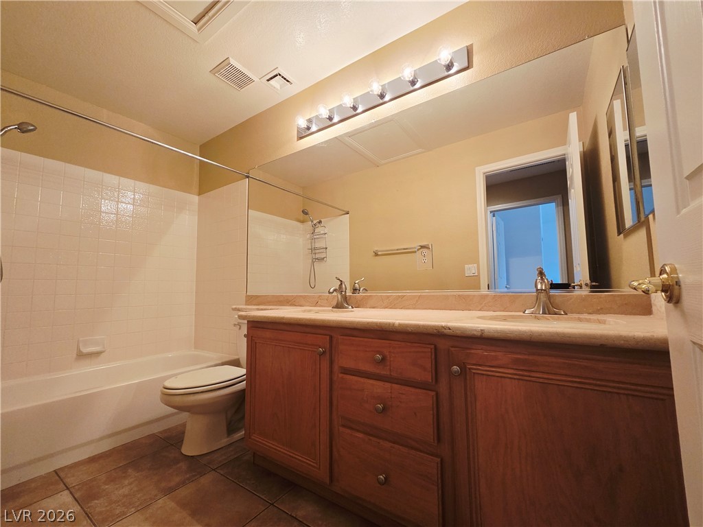 1265 Moon Vision Street Henderson, NV 89052 - Photo 30 of 35 Bathroom featuring double vanity, shower / bathtub combination, and dark tile patterned floors