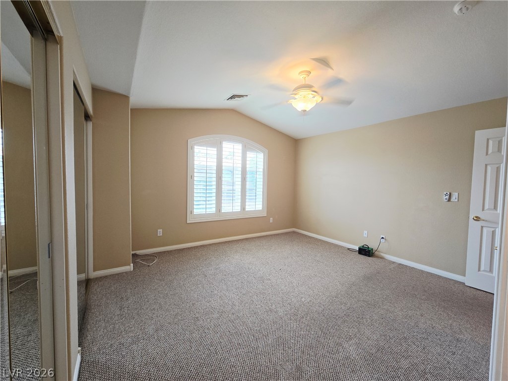 1265 Moon Vision Street Henderson, NV 89052 - Photo 33 of 35 Unfurnished bedroom featuring lofted ceiling, carpet flooring, ceiling fan, and a closet