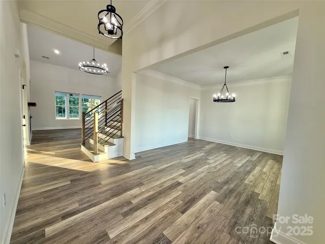 an empty room with closet and windows