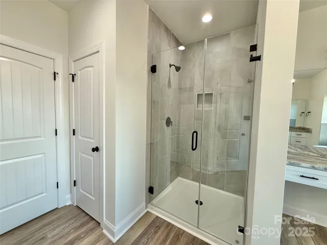 a spacious bathroom with a granite countertop tub sink and mirror