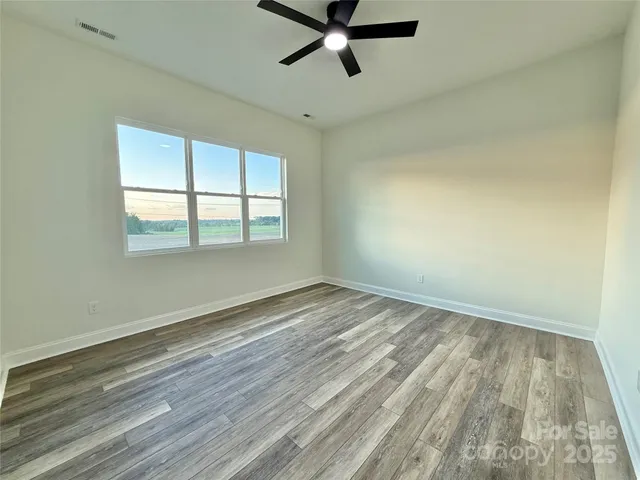 a bathroom with a granite countertop sink a toilet and shower