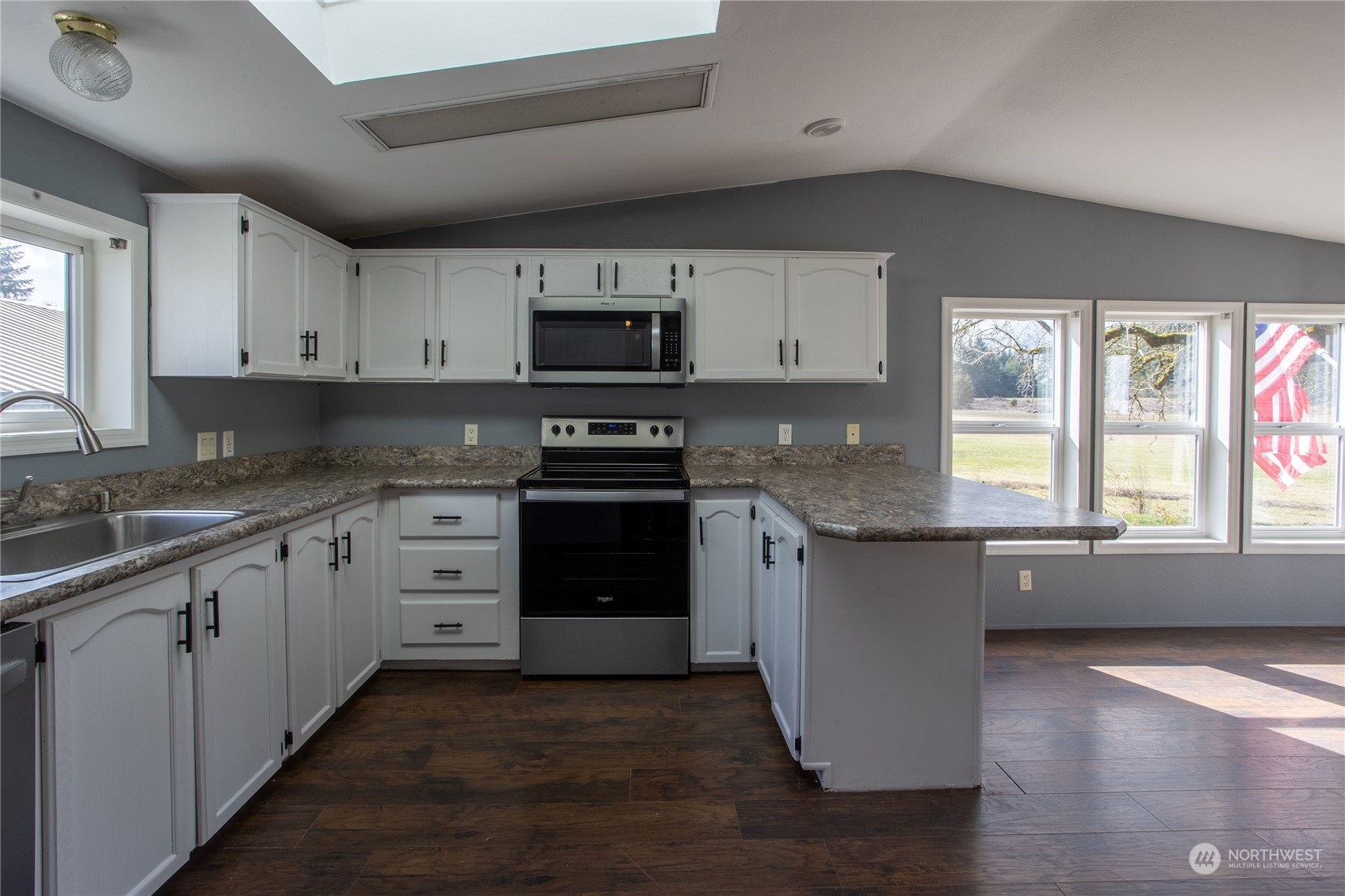 219 Lindbeck Road Winlock, WA 98596 - Photo 4 of 35 a kitchen with granite countertop a stove top oven sink and cabinets