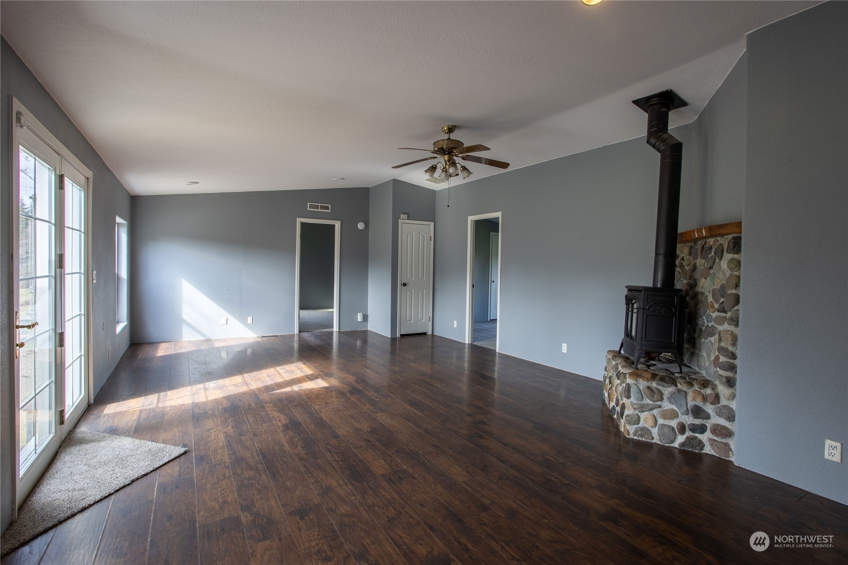 219 Lindbeck Road Winlock, WA 98596 - Photo 7 of 35 a view of a livingroom with wooden floor and a ceiling fan