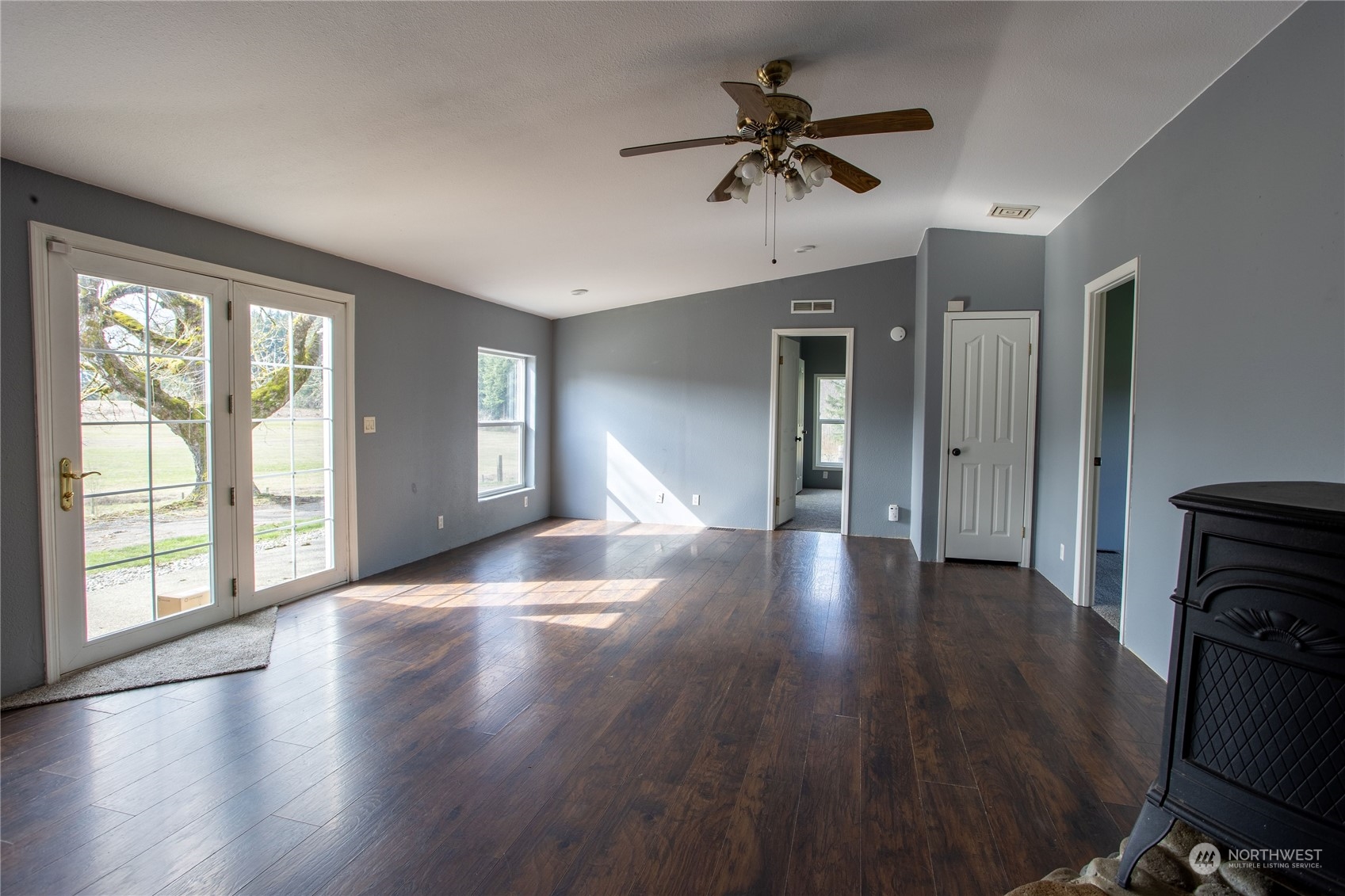 219 Lindbeck Road Winlock, WA 98596 - Photo 8 of 35 a view of an empty room with a window and wooden floor