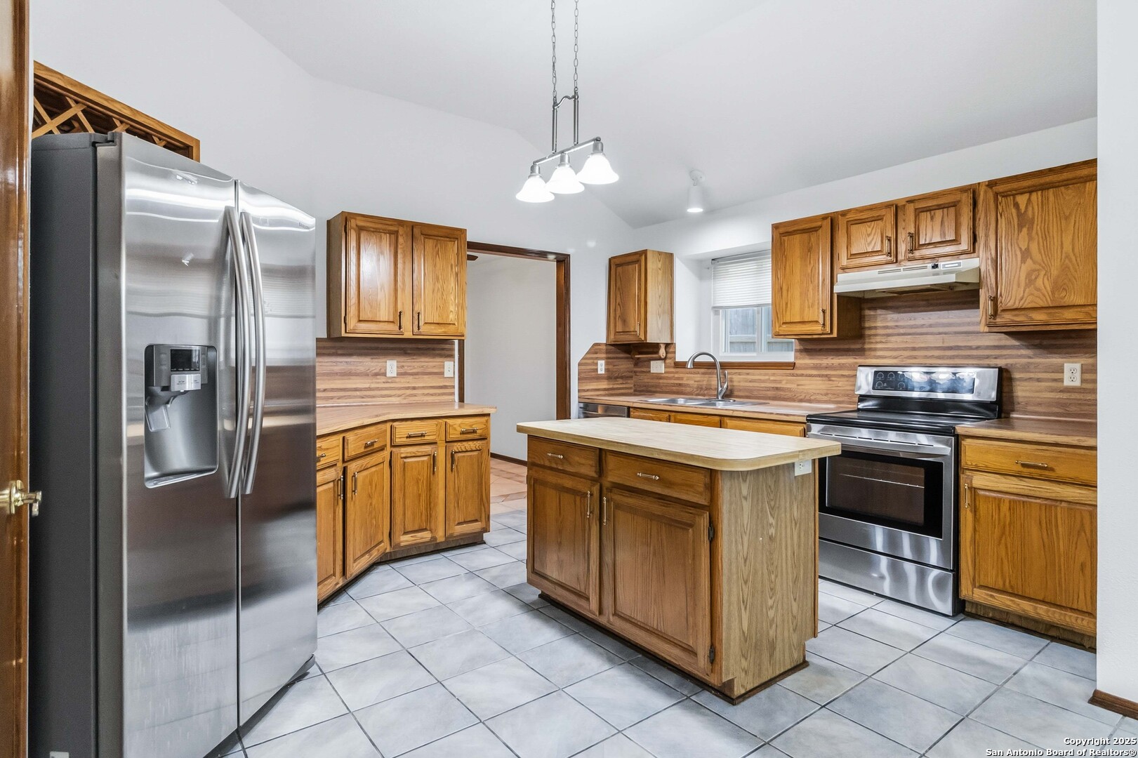 14658 Highland Ridge San Antonio, TX 78233 - Photo 12 of 35 a kitchen with stainless steel appliances granite countertop a sink stove and refrigerator