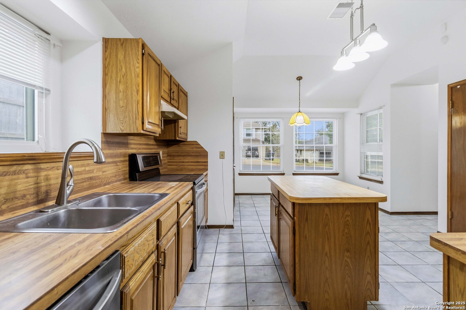 14658 Highland Ridge San Antonio, TX 78233 - Photo 15 of 35 a kitchen with a sink stove top oven and refrigerator