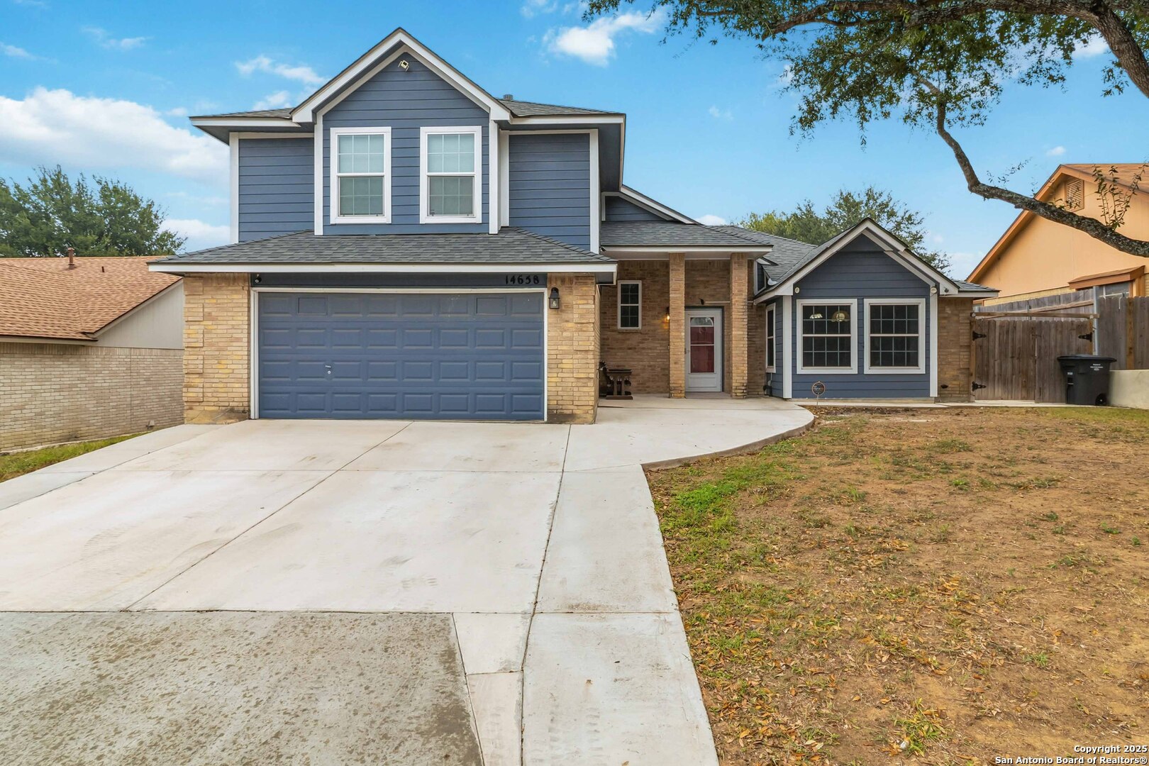 14658 Highland Ridge San Antonio, TX 78233 - Photo 7 of 35 a front view of a house with a garden and trees