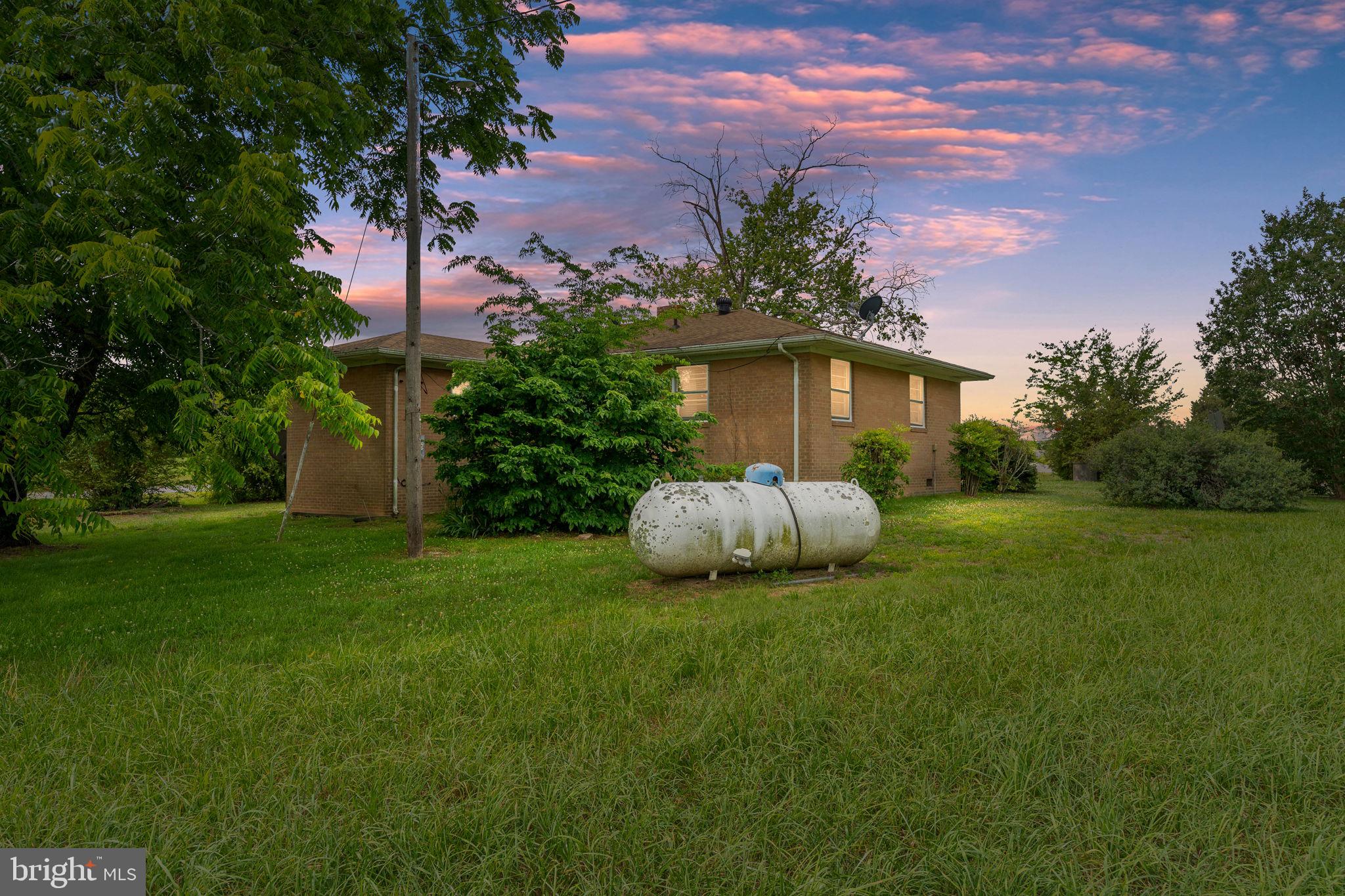 1440 Holly Farm Road Burkeville, VA 23922 - Photo 3 of 52 Charming home amid lush greenery.
