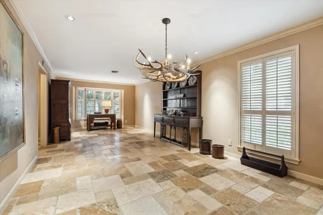 a view of a livingroom with a chandelier furniture and windows