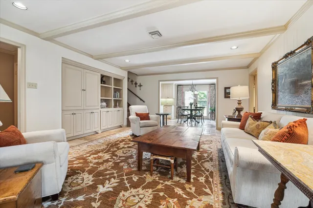 a living room with furniture wooden floor and a flat screen tv